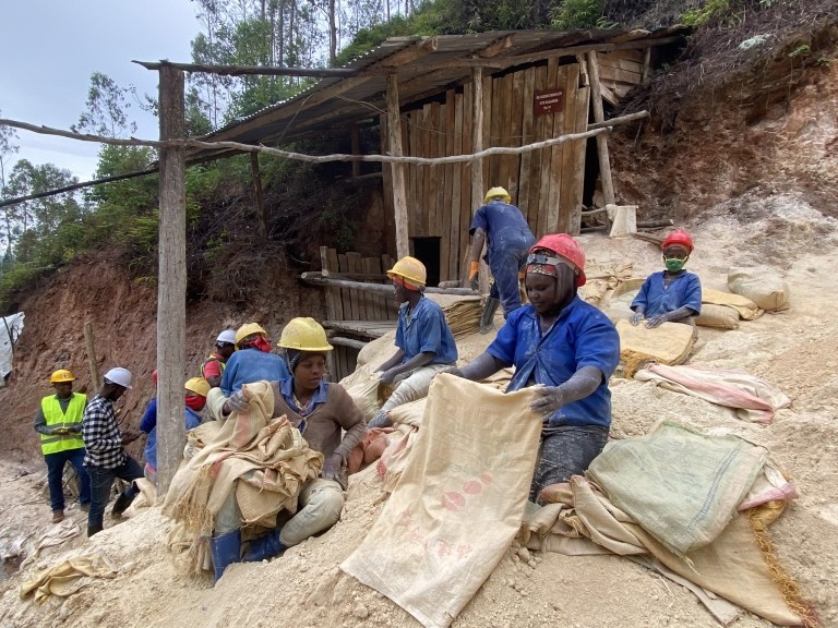 A group of women and men working at a mine site in Rwanda. Credit: Pact.